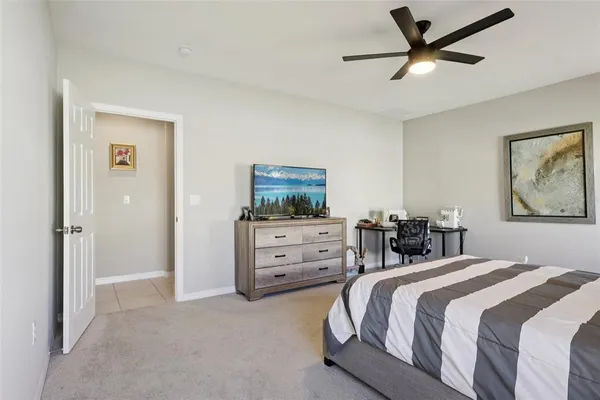 a bedroom with a bed and a chair