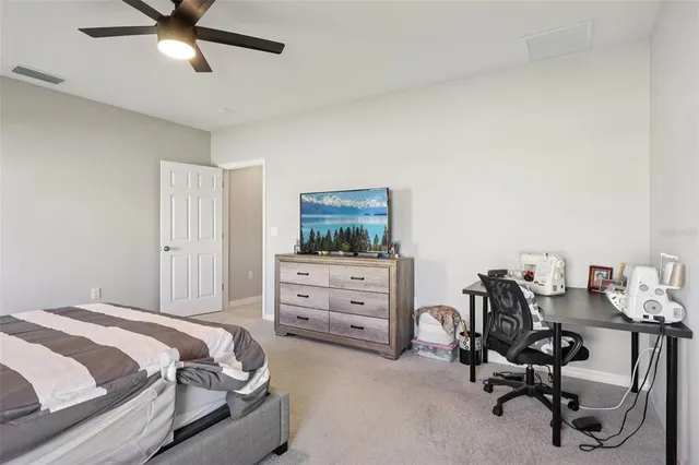 a bathroom with a granite countertop sink a toilet and shower