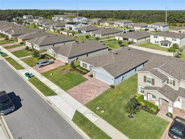 an aerial view of a house with yard swimming pool and ocean view