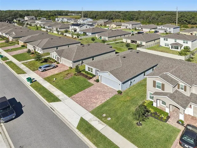 an aerial view of a house with yard swimming pool and ocean view