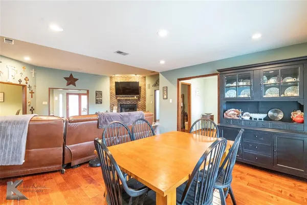 a dining room with furniture and a floor to ceiling window