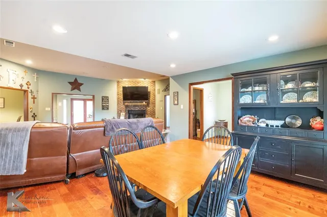 a dining room with furniture and a floor to ceiling window