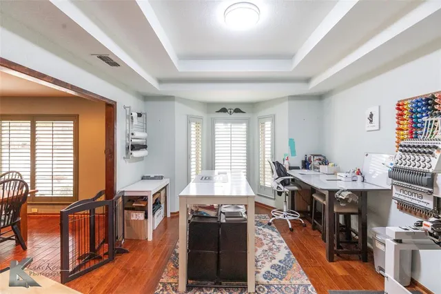 a living room with furniture a wooden floor and next to a window