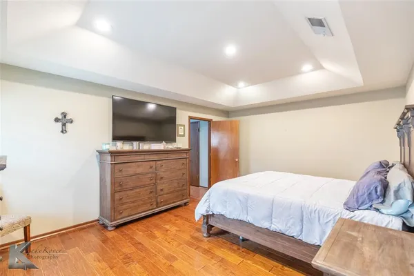 a bedroom with a bed and flat screen tv