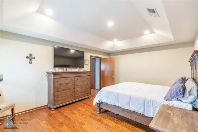 a bedroom with a bed and flat screen tv