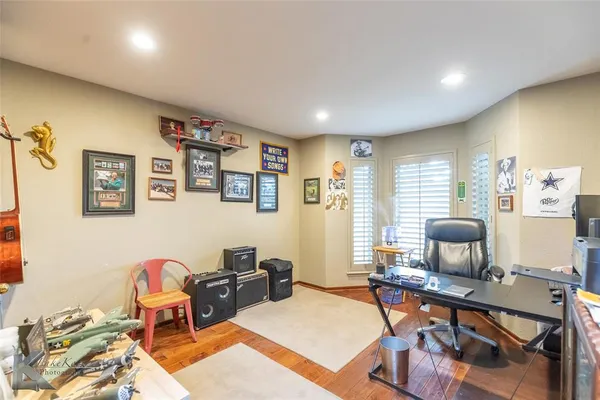 a living room with furniture a flat screen tv and a window