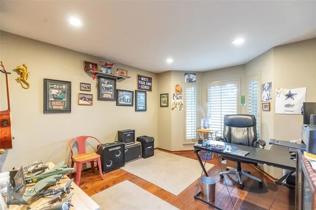 a living room with furniture a flat screen tv and a window
