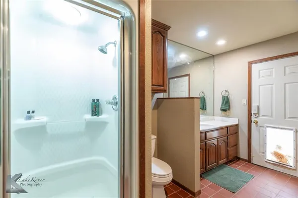 a bathroom with a toilet a sink and shower