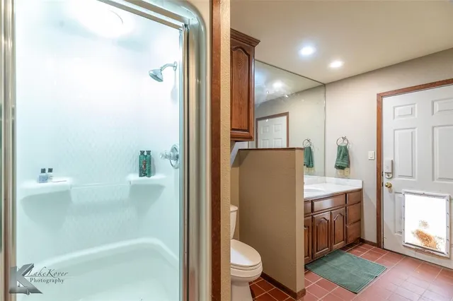 a bathroom with a toilet a sink and shower