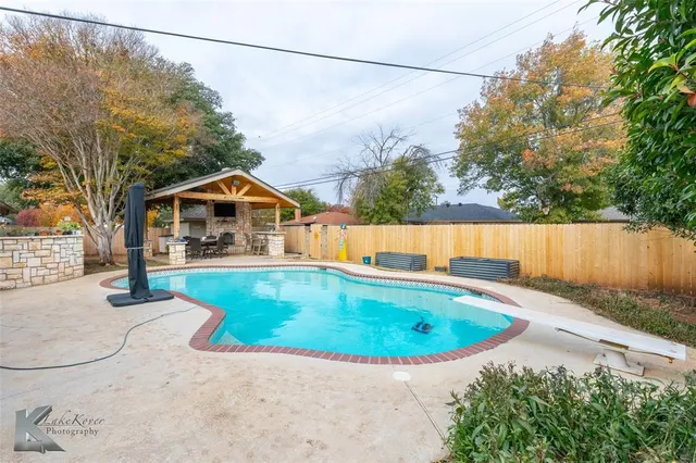 a view of swimming pool with a backyard