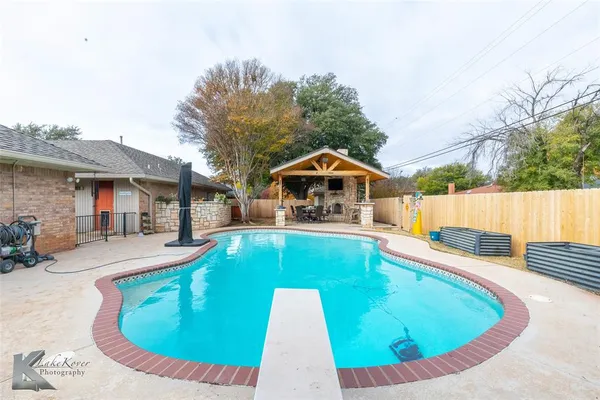 a view of a swimming pool with a patio