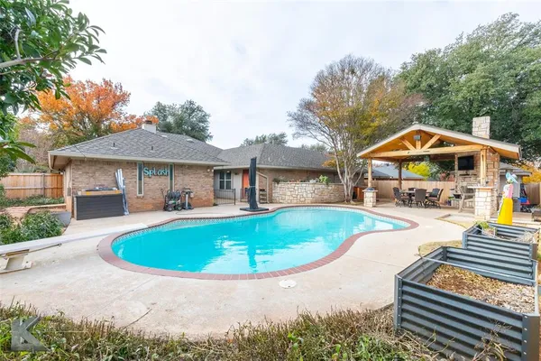 a view of house with swimming pool outdoor seating
