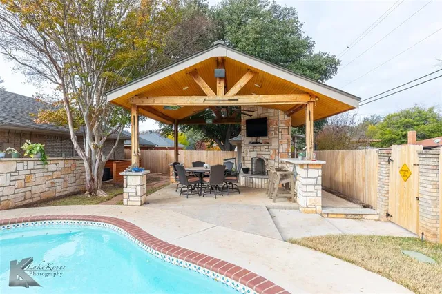 a view of swimming pool with sitting area