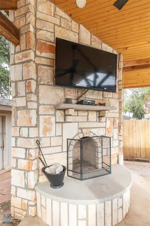 a view of a backyard with plants and large tree