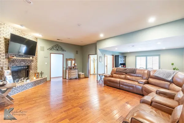 a living room with fireplace furniture and a flat screen tv