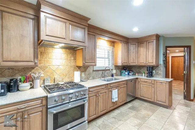 a kitchen with a stove top oven sink and cabinets