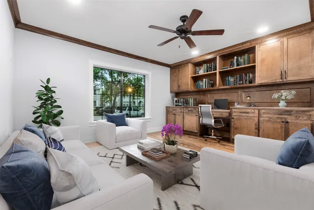 a living room with furniture fireplace and a large window
