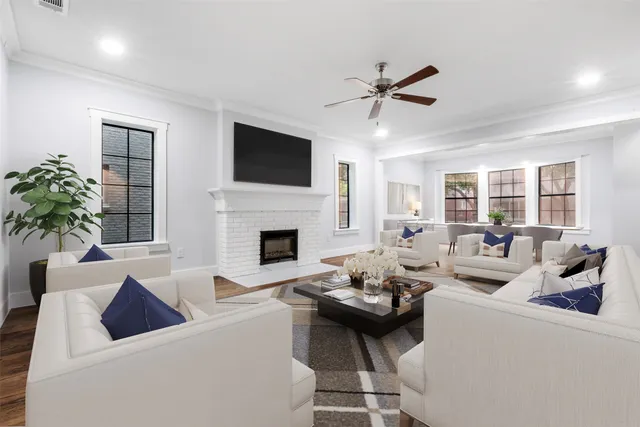 a living room with furniture a fireplace and a flat screen tv