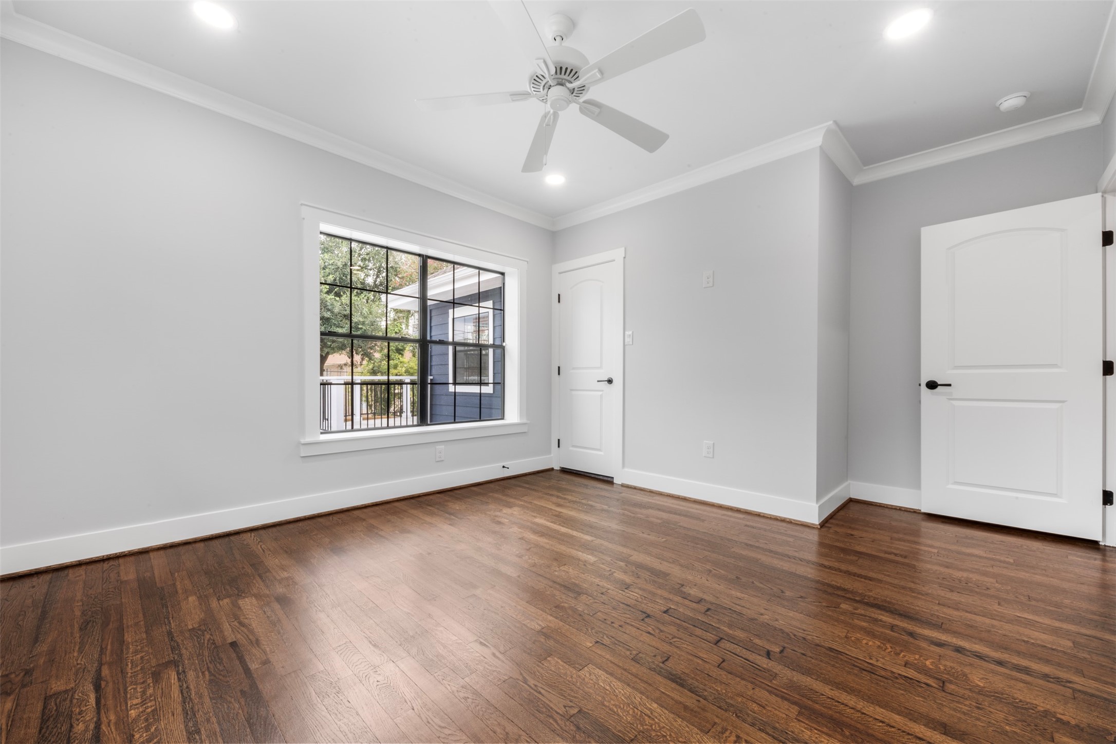 1723 Albans Road Houston, TX 77005 - Photo 32 of 50 an empty room with wooden floor chandelier fan and windows