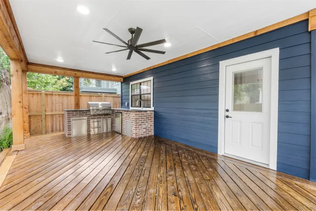 a view of a room with wooden floor fan and windows