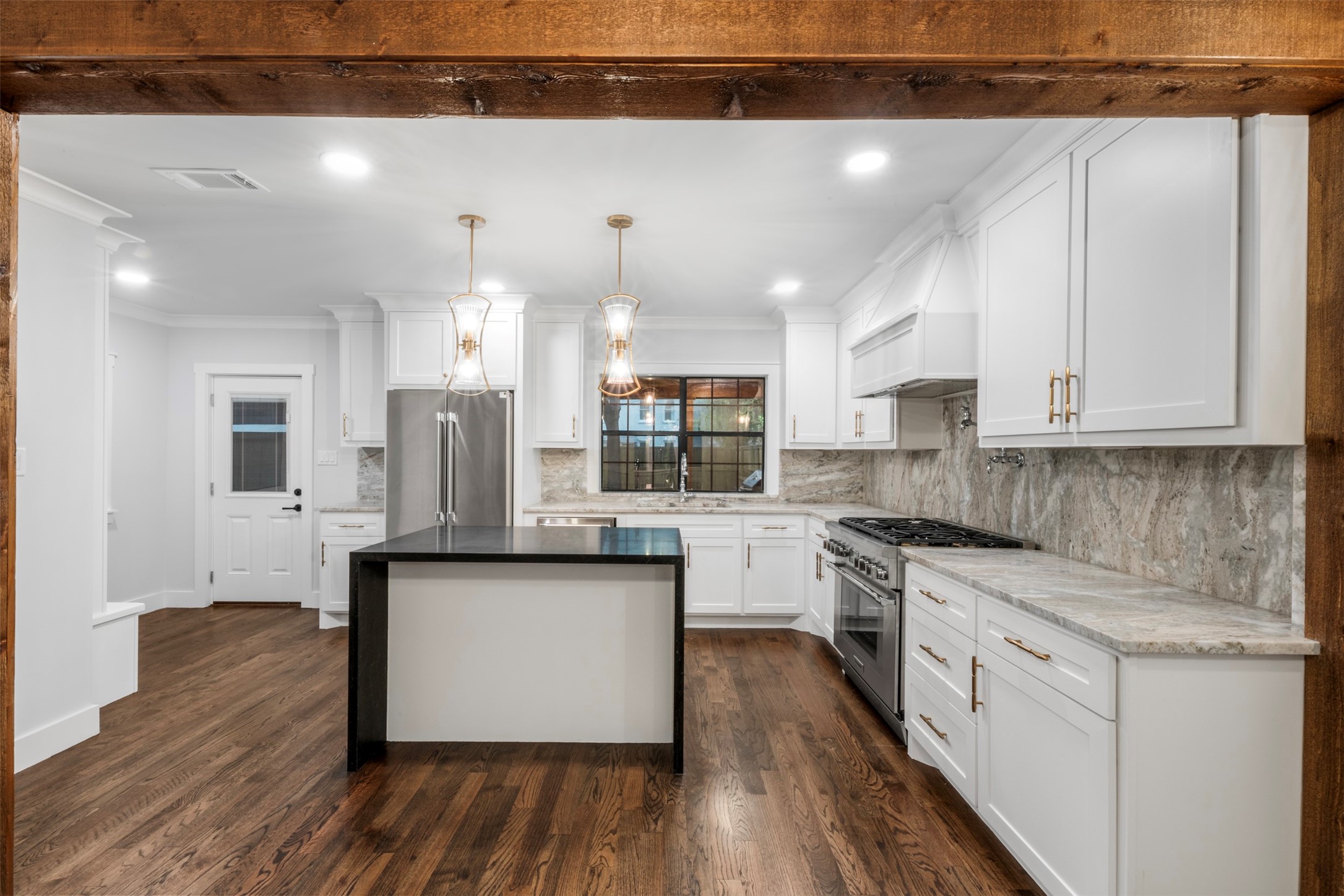 1723 Albans Road Houston, TX 77005 - Photo 9 of 50 a kitchen with stainless steel appliances granite countertop a stove top oven a sink and white cabinets with wooden floor
