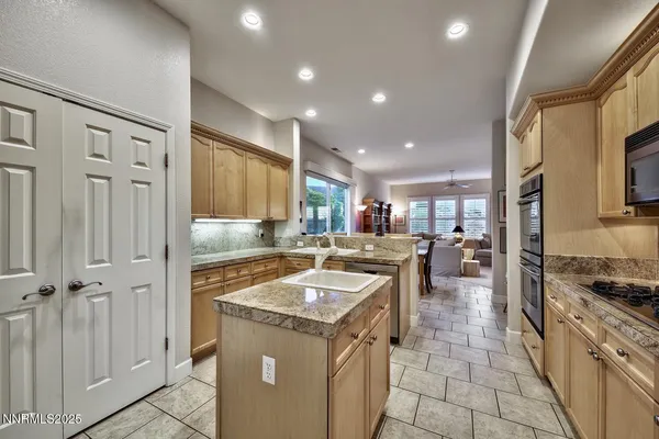 a kitchen with a stove a sink and a refrigerator