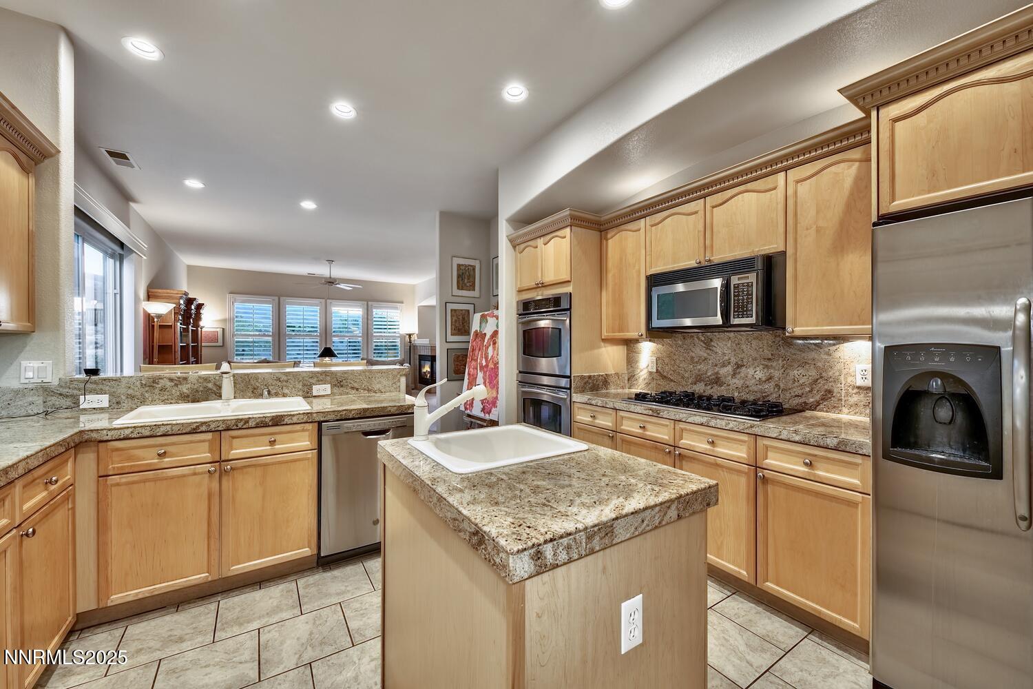 5710 North White Sands Road Reno, NV 89511 - Photo 19 of 35 a kitchen with a sink stove and cabinets