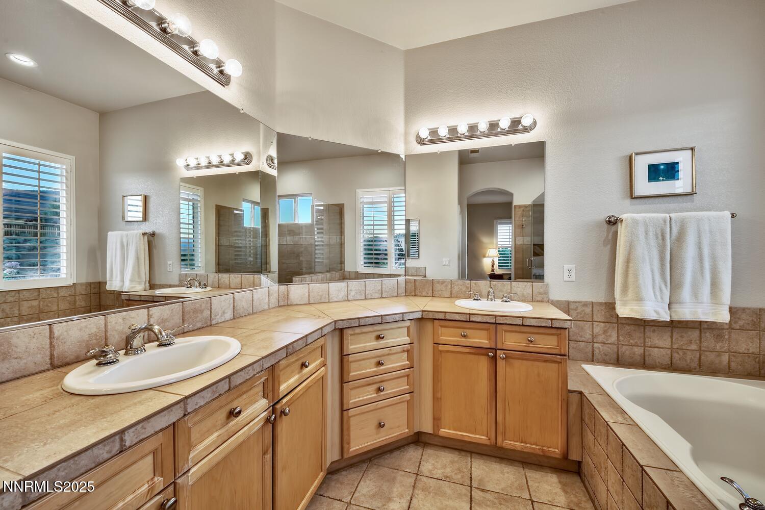 5710 North White Sands Road Reno, NV 89511 - Photo 22 of 35 a bathroom with a granite countertop sink and a mirror