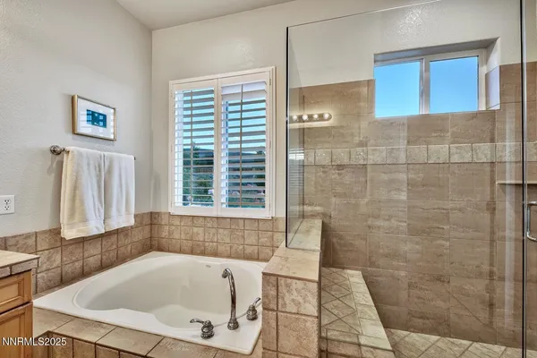 a bathroom with shower and bathtub