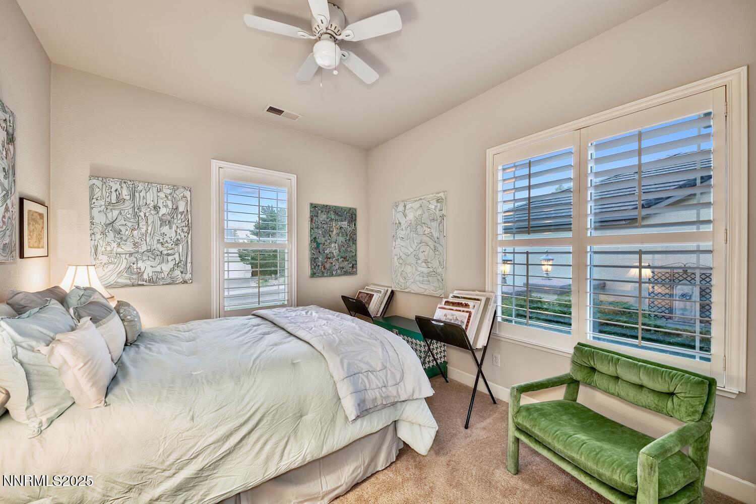 5710 North White Sands Road Reno, NV 89511 - Photo 24 of 35 a bedroom with a bed a large window and a chandelier