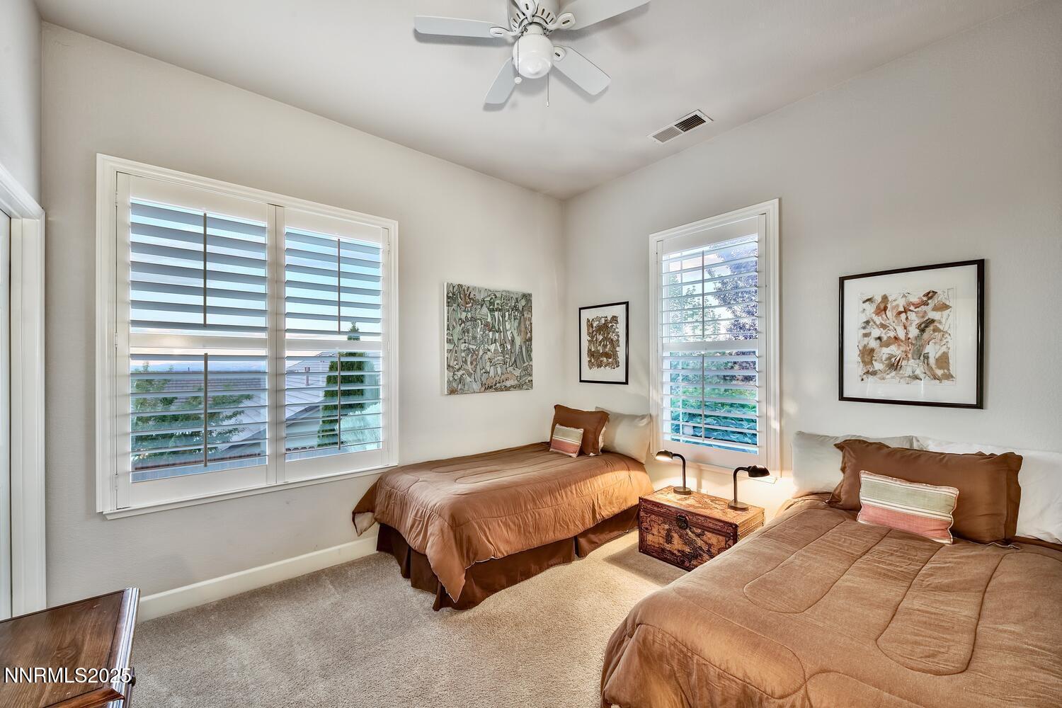5710 North White Sands Road Reno, NV 89511 - Photo 25 of 35 a spacious bedroom with two beds and a large window