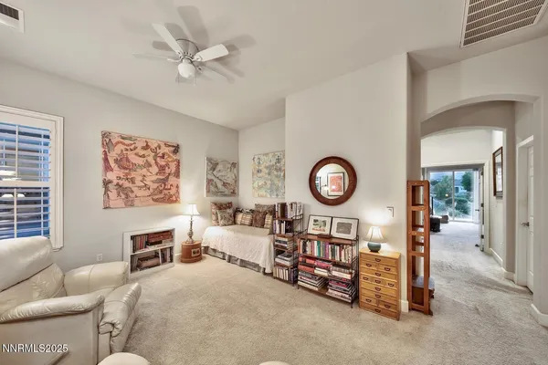 a living room with furniture a clock and a large window