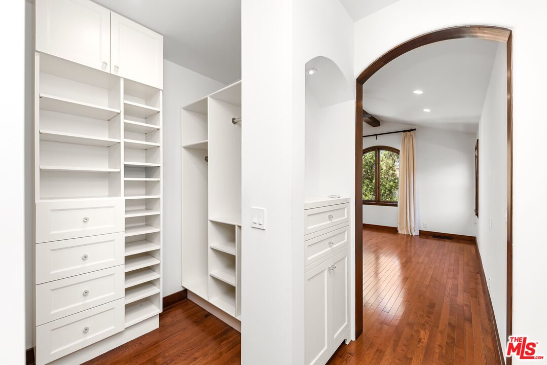 1039 Hi Point Street Los Angeles, CA 90035 - Photo 11 of 27 a view of walk in closet with empty racks