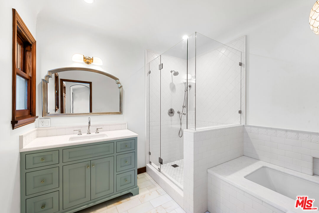 1039 Hi Point Street Los Angeles, CA 90035 - Photo 12 of 27 a bathroom with a tub sink and mirror