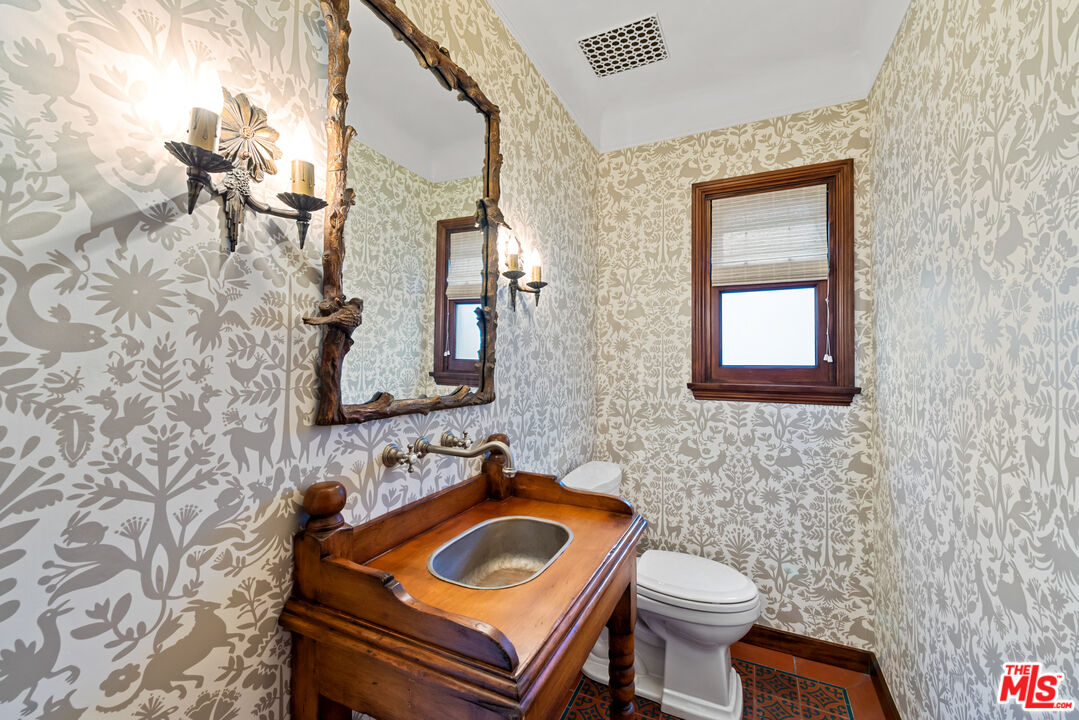 1039 Hi Point Street Los Angeles, CA 90035 - Photo 17 of 27 a bathroom with a toilet sink and mirror