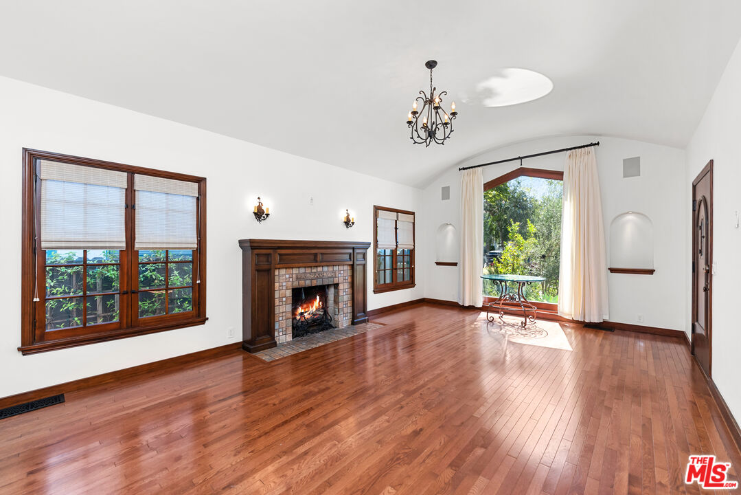 1039 Hi Point Street Los Angeles, CA 90035 - Photo 2 of 27 a view of an empty room with wooden floor and a window