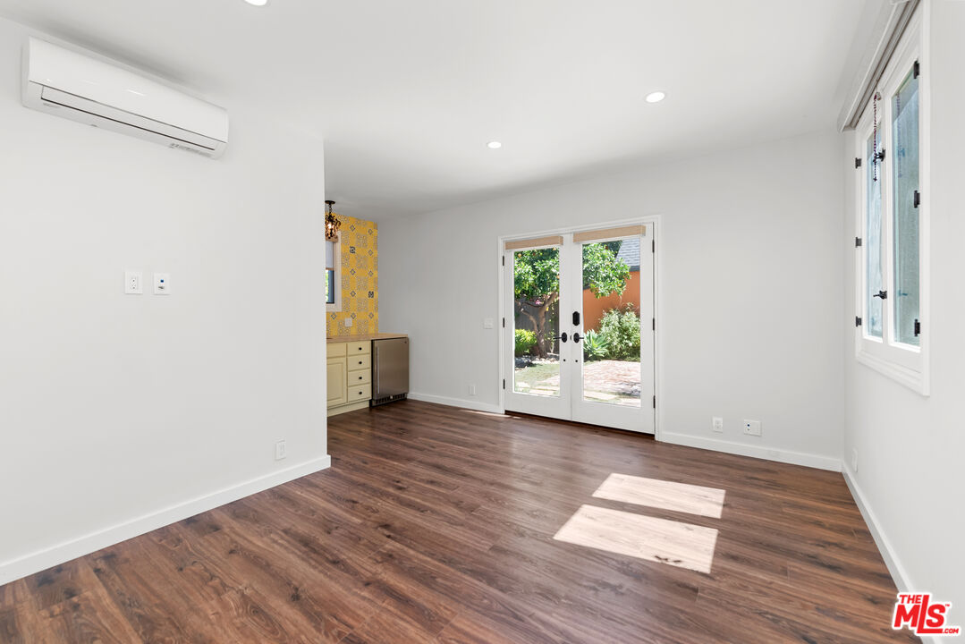 1039 Hi Point Street Los Angeles, CA 90035 - Photo 24 of 27 a view of an empty room with wooden floor and a window