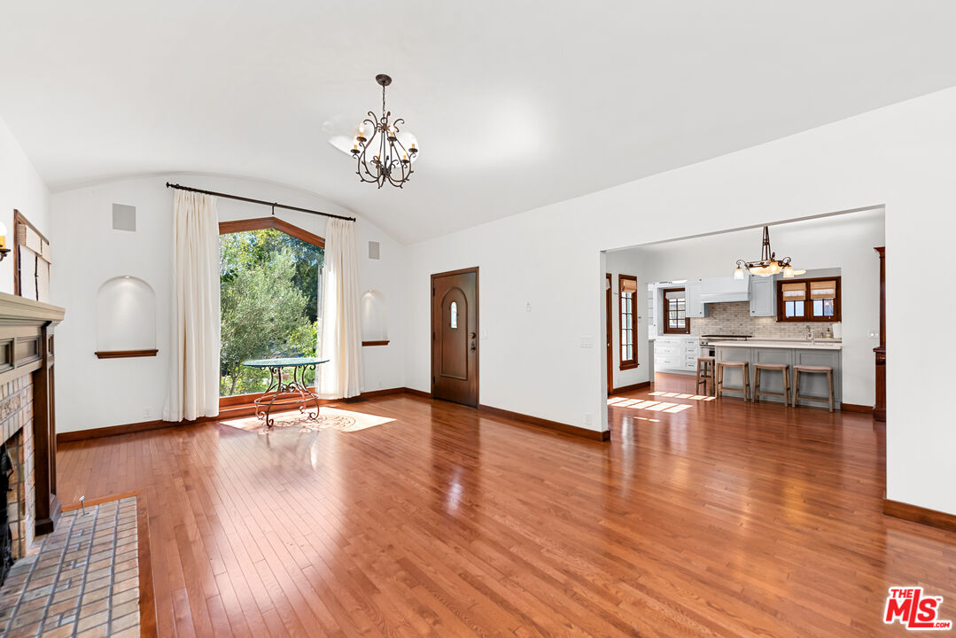 1039 Hi Point Street Los Angeles, CA 90035 - Photo 3 of 27 a view of an empty room with window and wooden floor