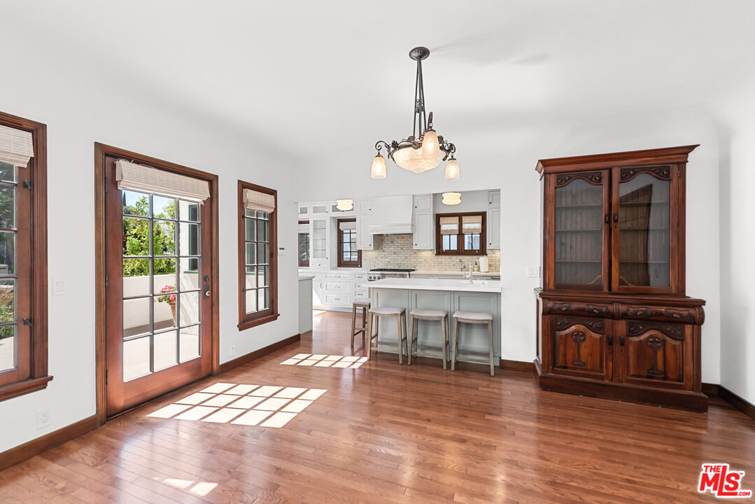 1039 Hi Point Street Los Angeles, CA 90035 - Photo 4 of 27 a view of a livingroom with furniture wooden floor windows and a chandelier