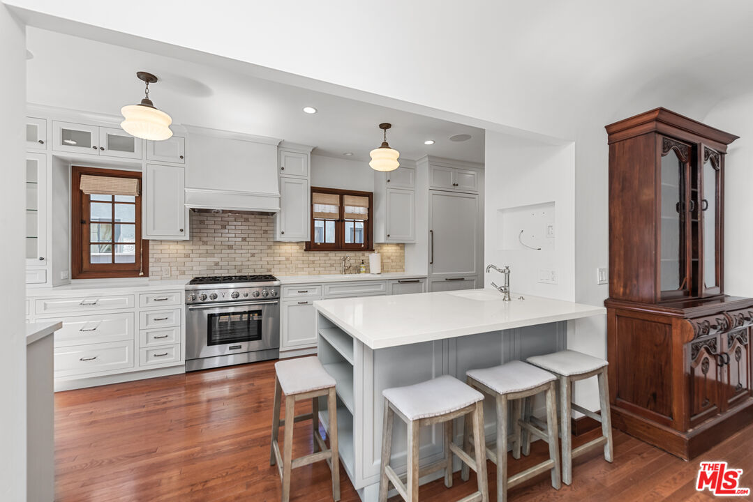 1039 Hi Point Street Los Angeles, CA 90035 - Photo 5 of 27 a kitchen with granite countertop a sink appliances cabinets and furniture