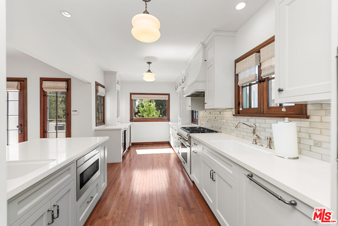 1039 Hi Point Street Los Angeles, CA 90035 - Photo 6 of 27 a large kitchen with a lot of counter space and wooden floor