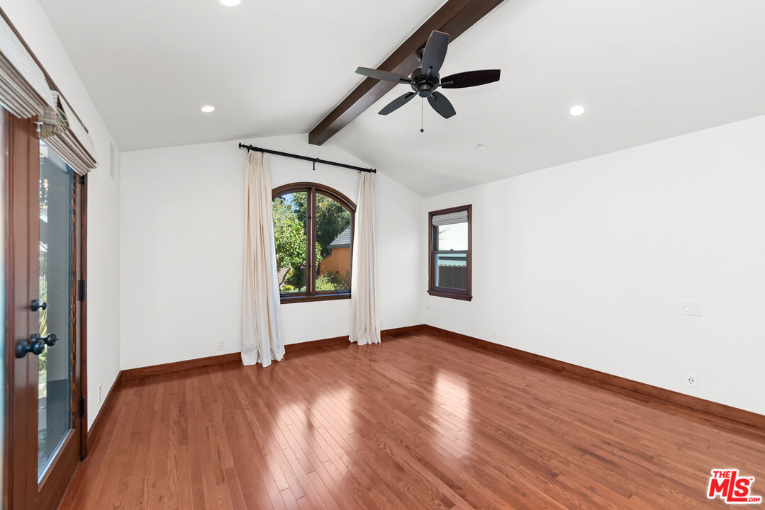 1039 Hi Point Street Los Angeles, CA 90035 - Photo 9 of 27 wooden floor in an empty room with a window