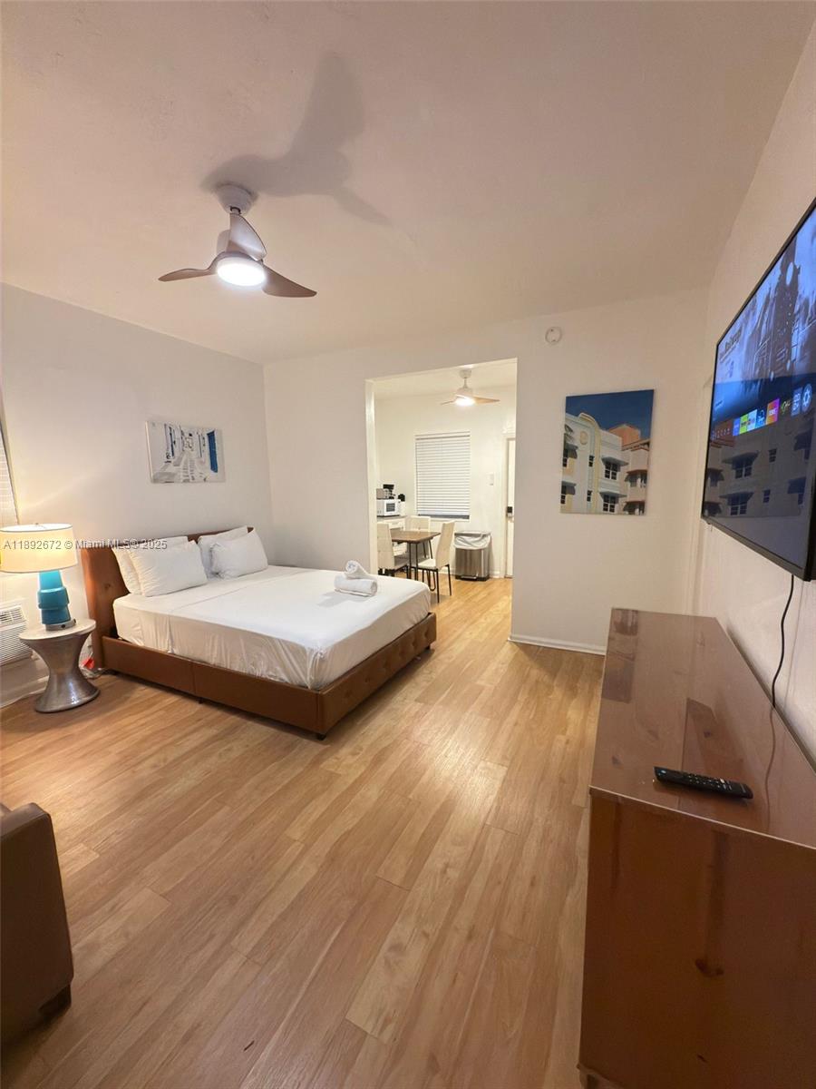 545 Michigan Avenue, Unit 6 Miami Beach, FL 33139 - Photo 2 of 13 a spacious bedroom with a bed and a flat screen tv