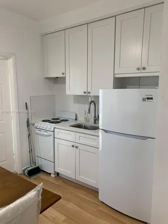 a kitchen with granite countertop cabinets and white appliances