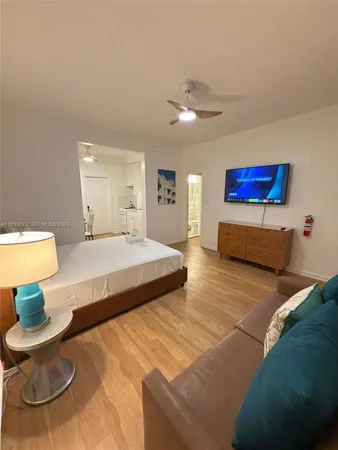 a spacious bedroom with a bed and a couch