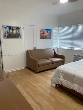 a living room with couches and painting on the wall