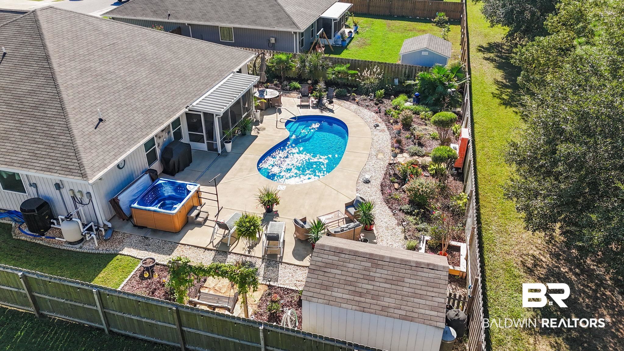 345 Hartenstein Road Foley, AL 36535 - Photo 45 of 47 View of pool featuring a patio area and a hot tub