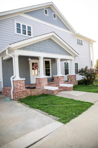 a front view of house with yard and outdoor seating