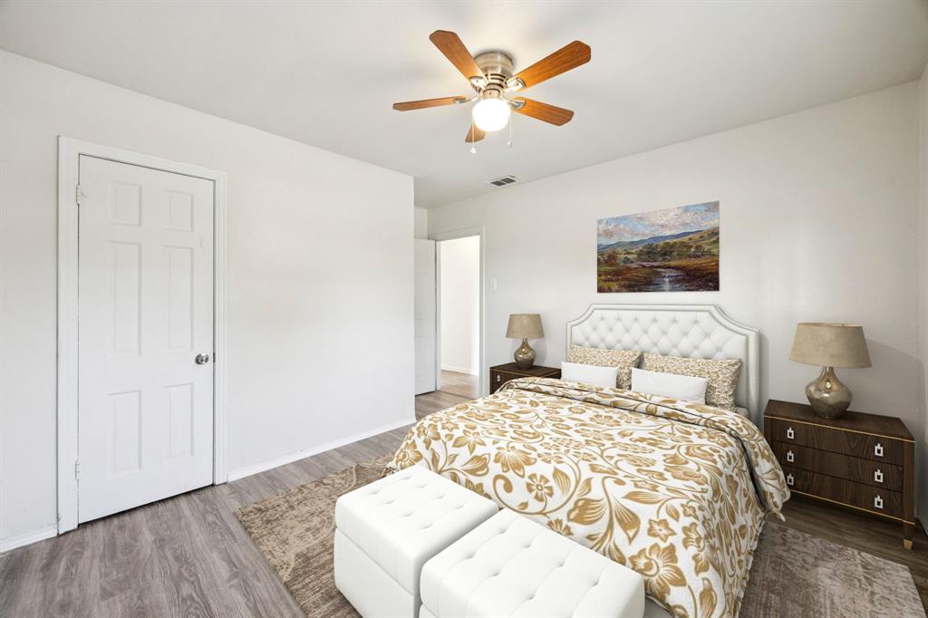 3228 Emmett Street Dallas, TX 75211 - Photo 11 of 25 a bedroom with a bed and a chandelier