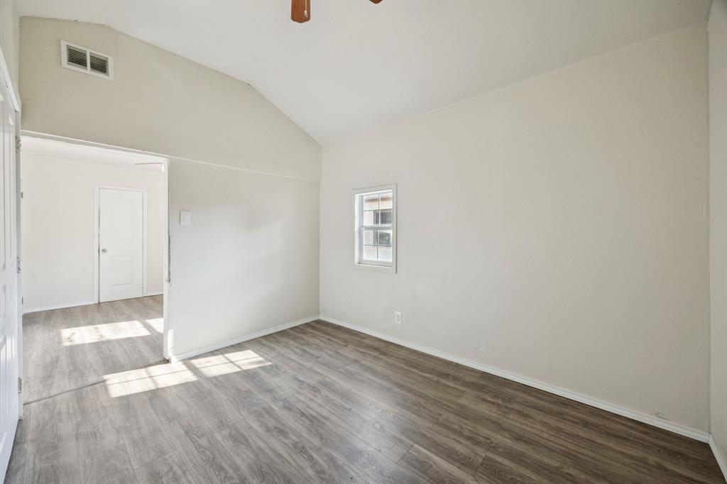 3228 Emmett Street Dallas, TX 75211 - Photo 19 of 25 a view of an empty room with wooden floor